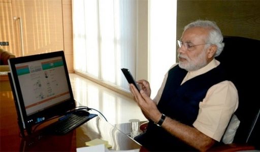 Narendra Modi using phone and PC