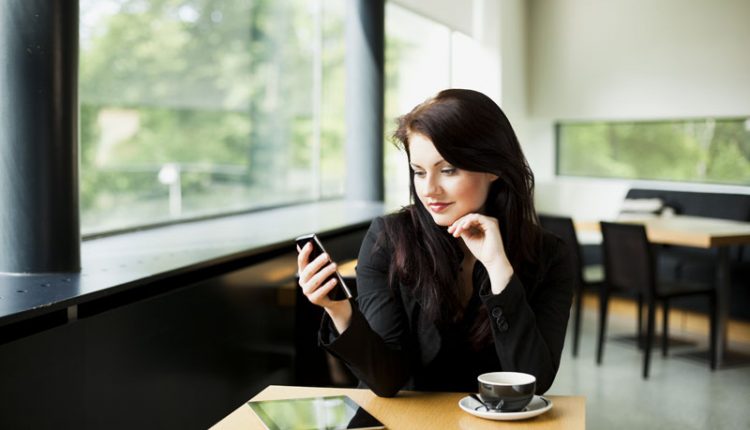 Single girl using smartphone in Restaurant 