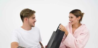 Boyfriend giving gift to girlfriend, surprise