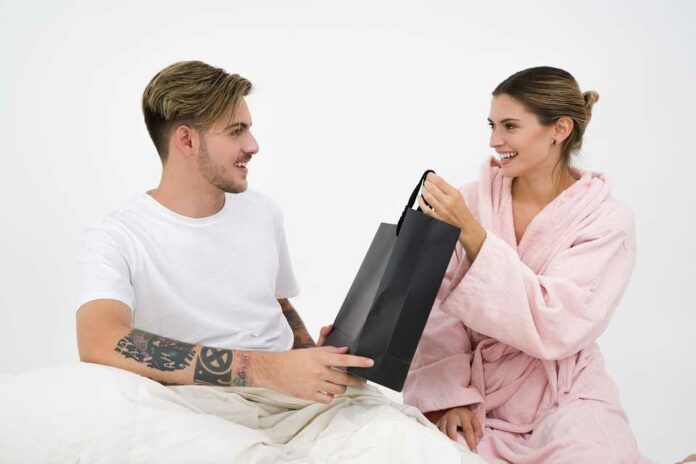 Boyfriend giving gift to girlfriend, surprise