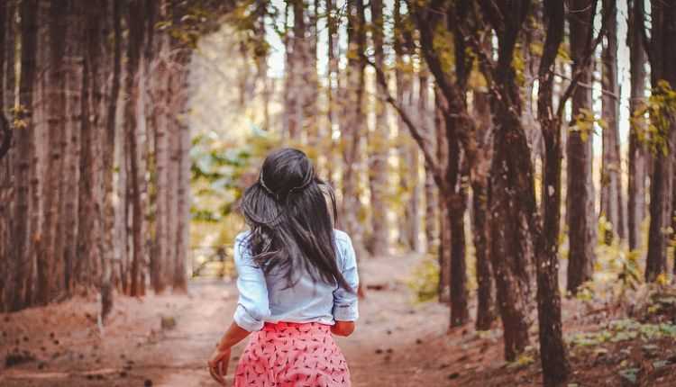 Girl walking in forest